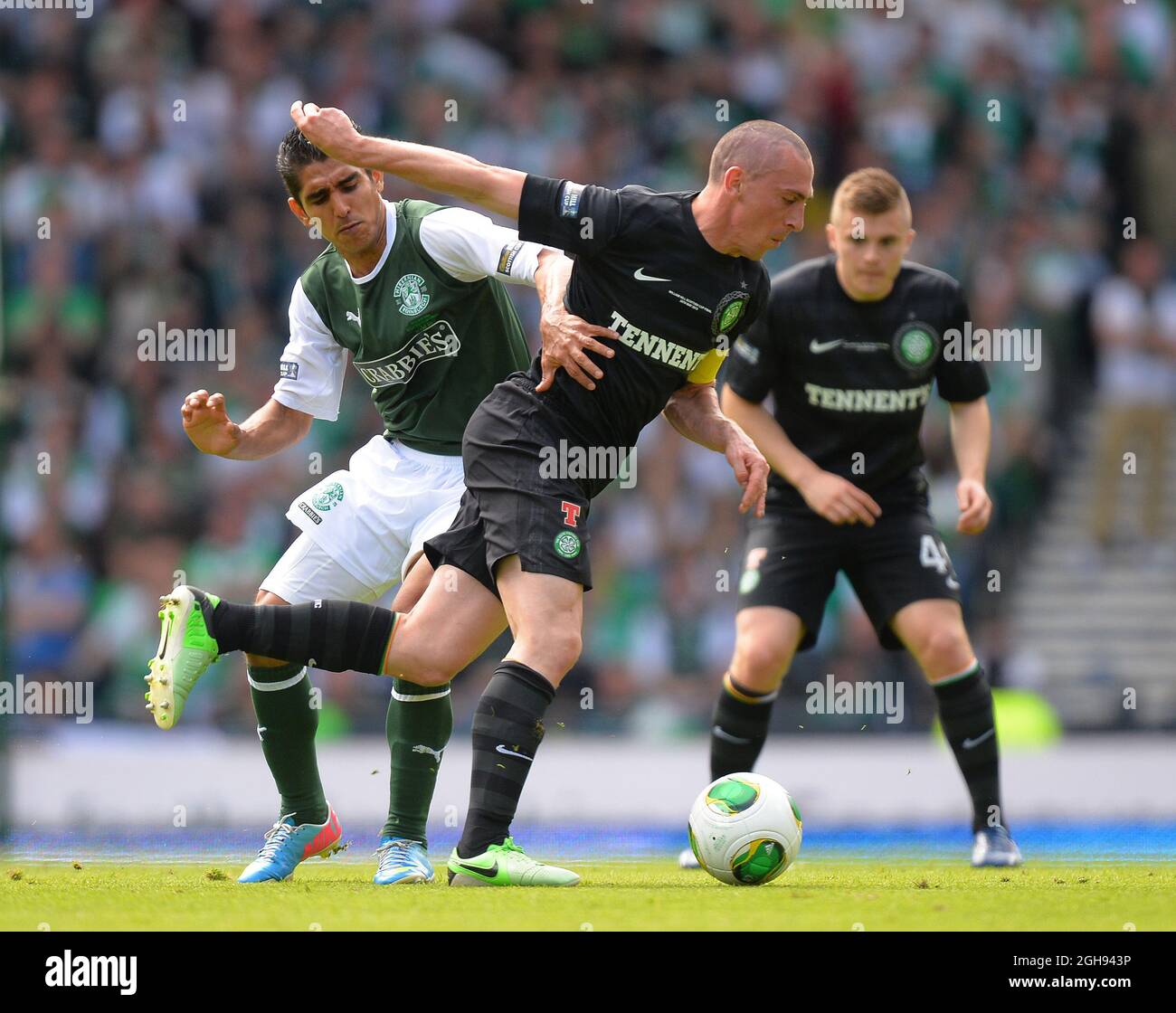 Celtic's Scott Brown holds off the challenge by Hibernian's Jorge Claros during the William Hill Scottish Cup Final between Hibernian and Celtic at the Hampden Park Stadium in Glasgow, Scotland on May 26, 2013. Picture Simon Bellis Stock Photo
