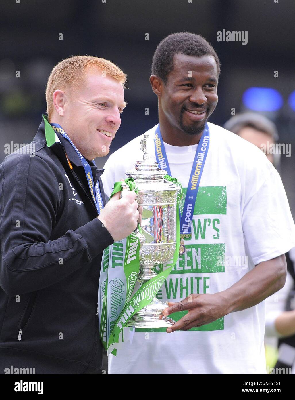 Celtic's Neil Lennon with Celtic's Efe Ambrose and the Scottish Cup during the William Hill Scottish Cup Final between Hibernian and Celtic at the Hampden Park Stadium in Glasgow, Scotland on May 26, 2013. Picture Simon Bellis Stock Photo
