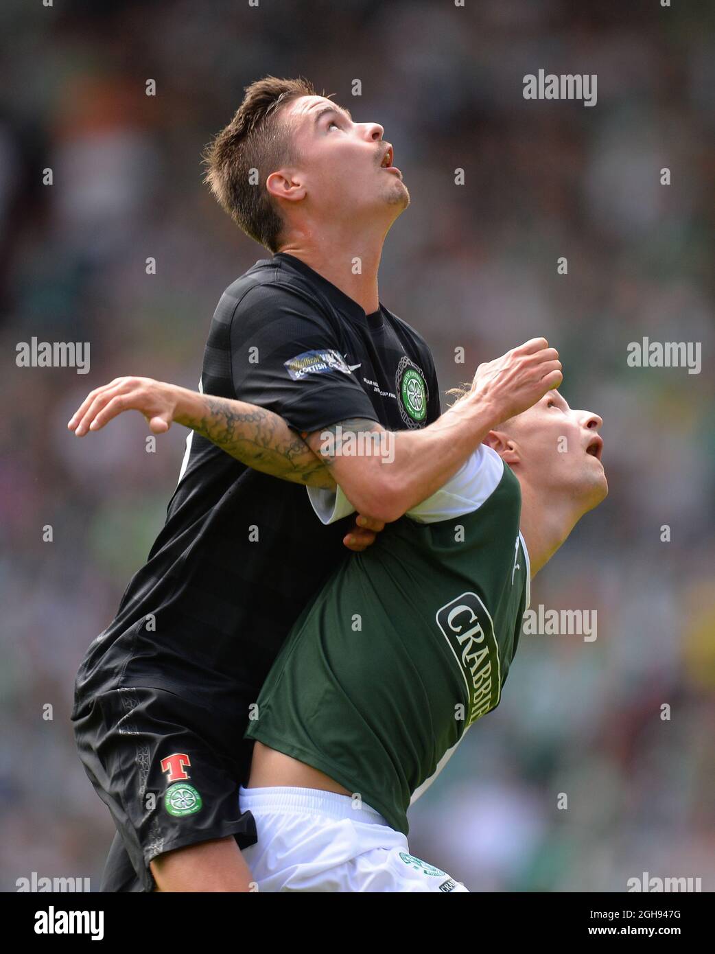Mikael Lustig of Celtic tussles with Leigh Griffiths of Hibernian during the William Hill Scottish Cup Final between Hibernian and Celtic at the Hampden Park Stadium in Glasgow, Scotland on May 26, 2013. Picture Simon Bellis Stock Photo