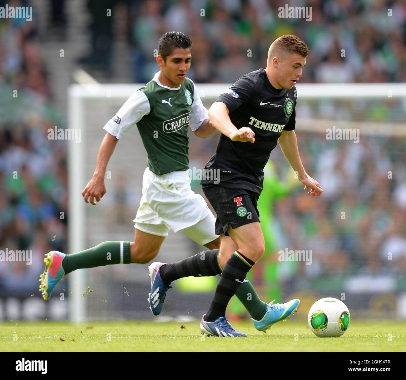 James Forrest of Celtic out paces Jorge Claros of Hibernian during the William Hill Scottish Cup Final between Hibernian and Celtic at the Hampden Park Stadium in Glasgow, Scotland on May 26, 2013. Picture Simon Bellis Stock Photo