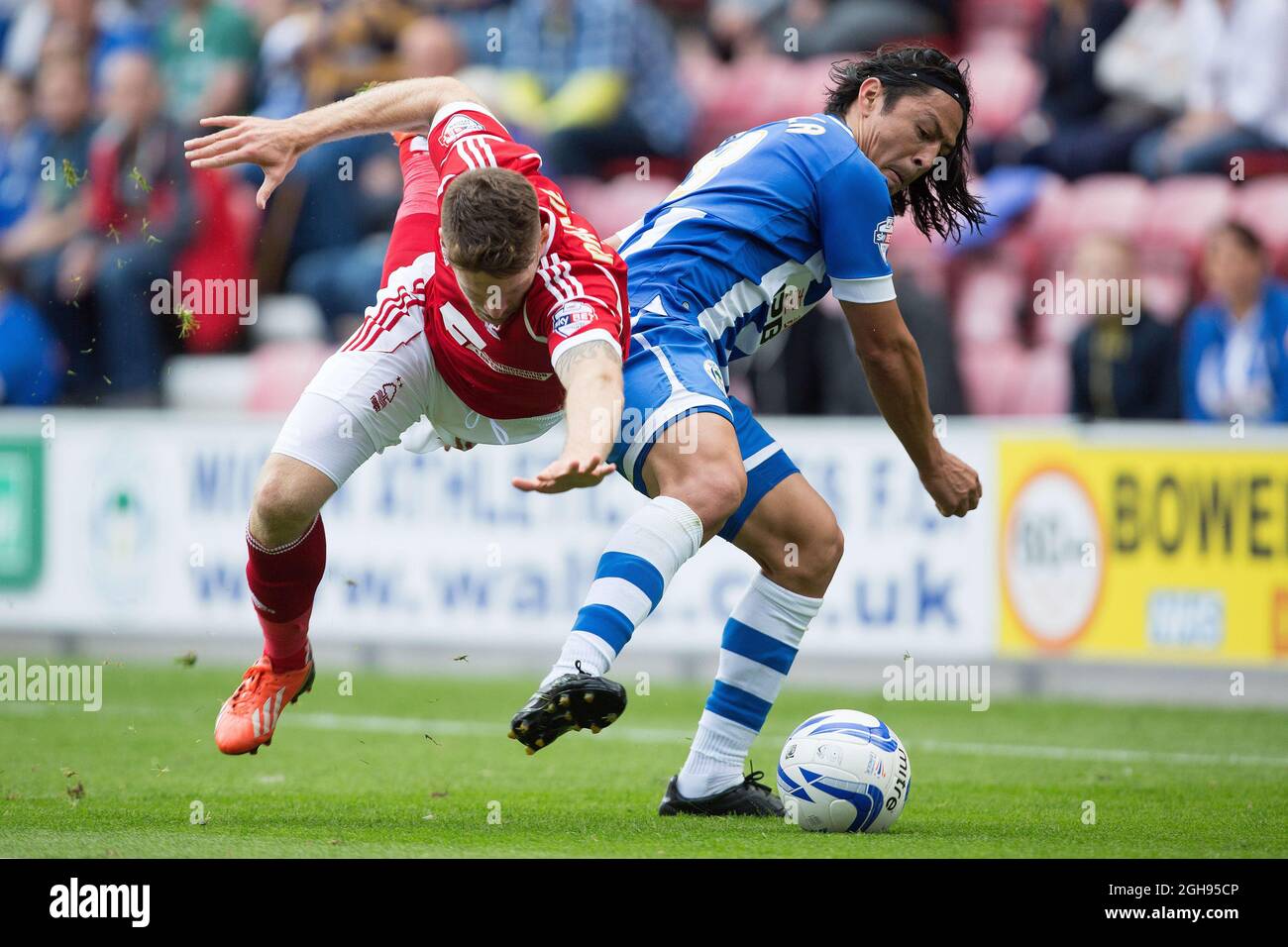 Forest's Jamie Mackie and Wigan's Roger Espinoza in action during the Sky Bet Football League Championship match between Wigan Athletic and Nottingham Forest at the DW Stadium, Wigan on August 31, 2013. Stock Photo