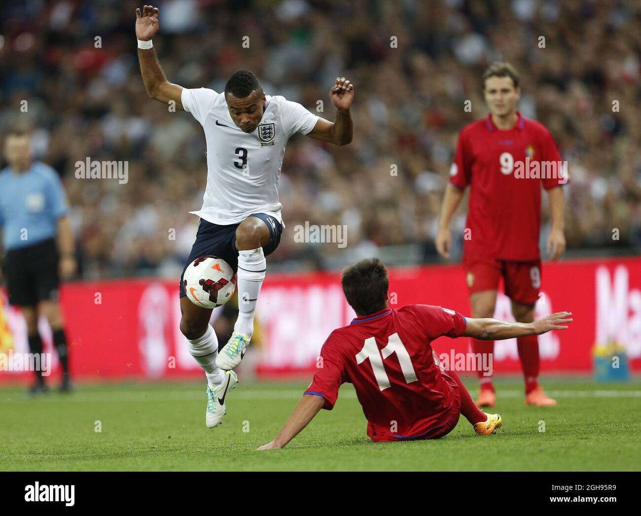 England's Ashley Cole tussles with Moldova's Serghei Georghiev during the 2014 FIFA World Cup Qualifier, Group H match between England and Moldova at the Wembley Stadium in London on September 6, 2013. Stock Photo