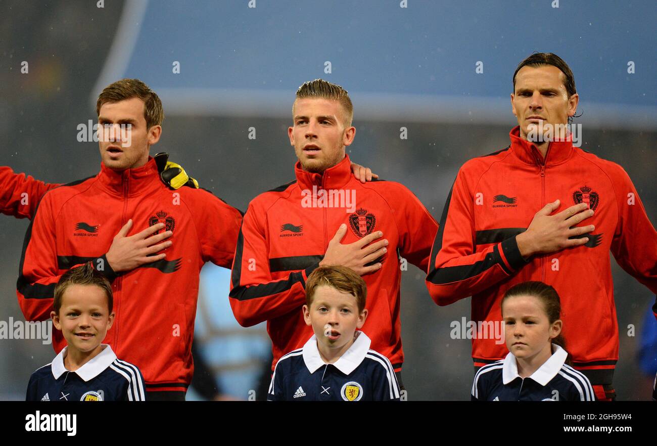 Nicolas Lombaerts, Toby Alderweireld and Daniel van Buyten of Belgium sing their national anthem during the 2014 FIFA World Cup Qualifying, Group A match between Scotland and Belgium at the Hampden Park Stadium in Glasgow, Scotland on September 6, 2013. Stock Photo