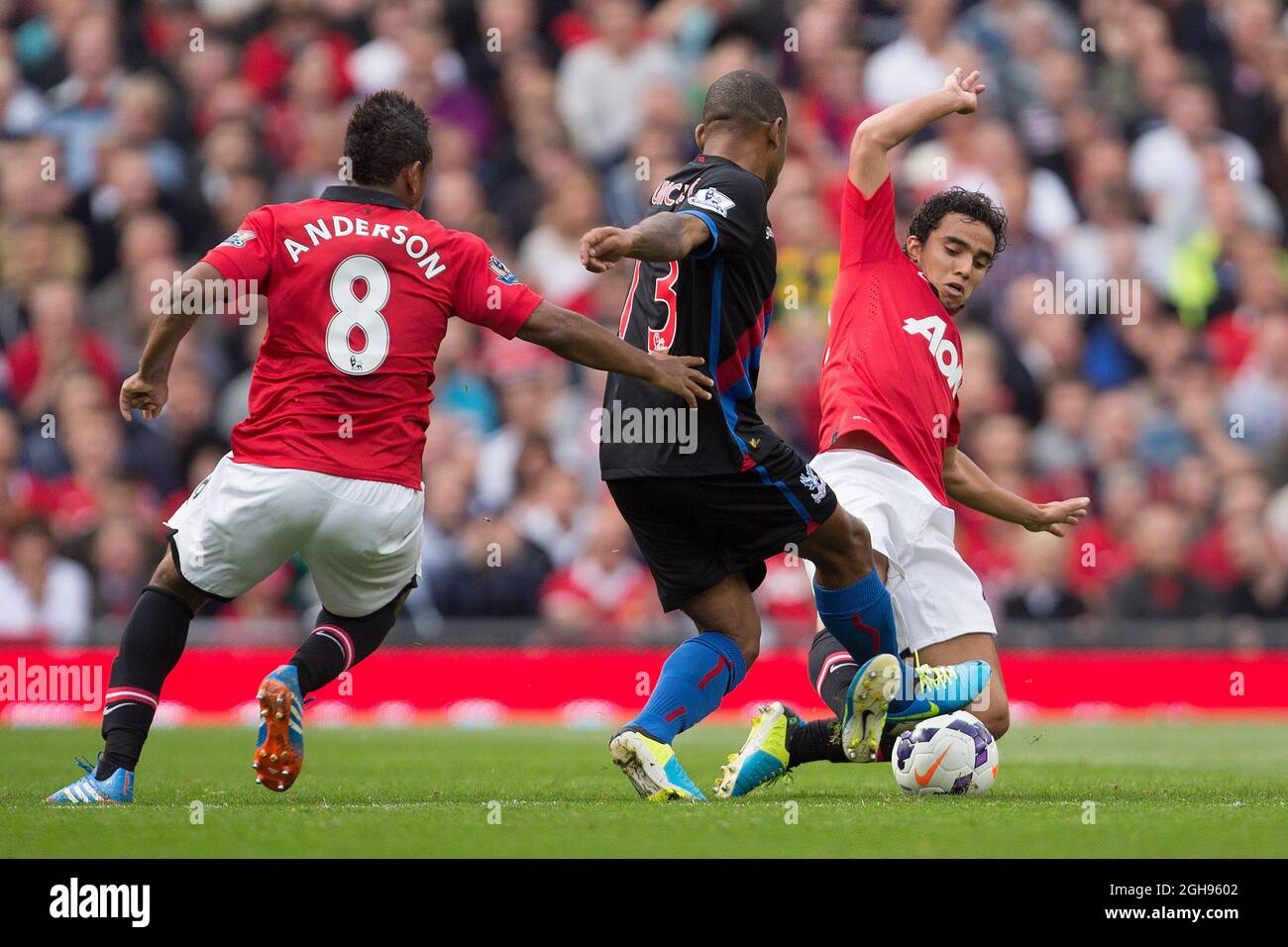 Rafael Pereira da Silva of Manchester United challenges Jason Puncheon of Crystal Palace during the Barclays Premier League match between Manchester United and Crystal Palace at Old Trafford, Manchester on September 14, 2013. Pic Philip Oldham. Stock Photo