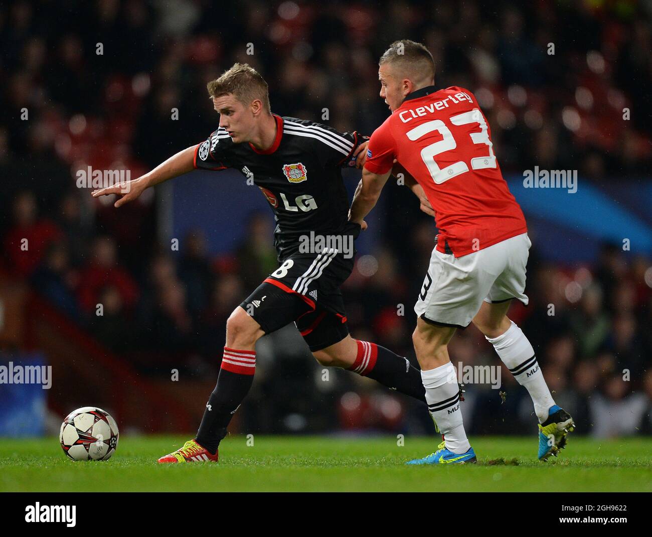 Lars Bender of Bayer Leverkusen tussles with Tom Cleverley of Manchester United during the UEFA Champions League Group A match between Manchester United and Bayer Leverkusen at Old Trafford in Manchester, United Kingdom on Sept. 17, 2013. Stock Photo