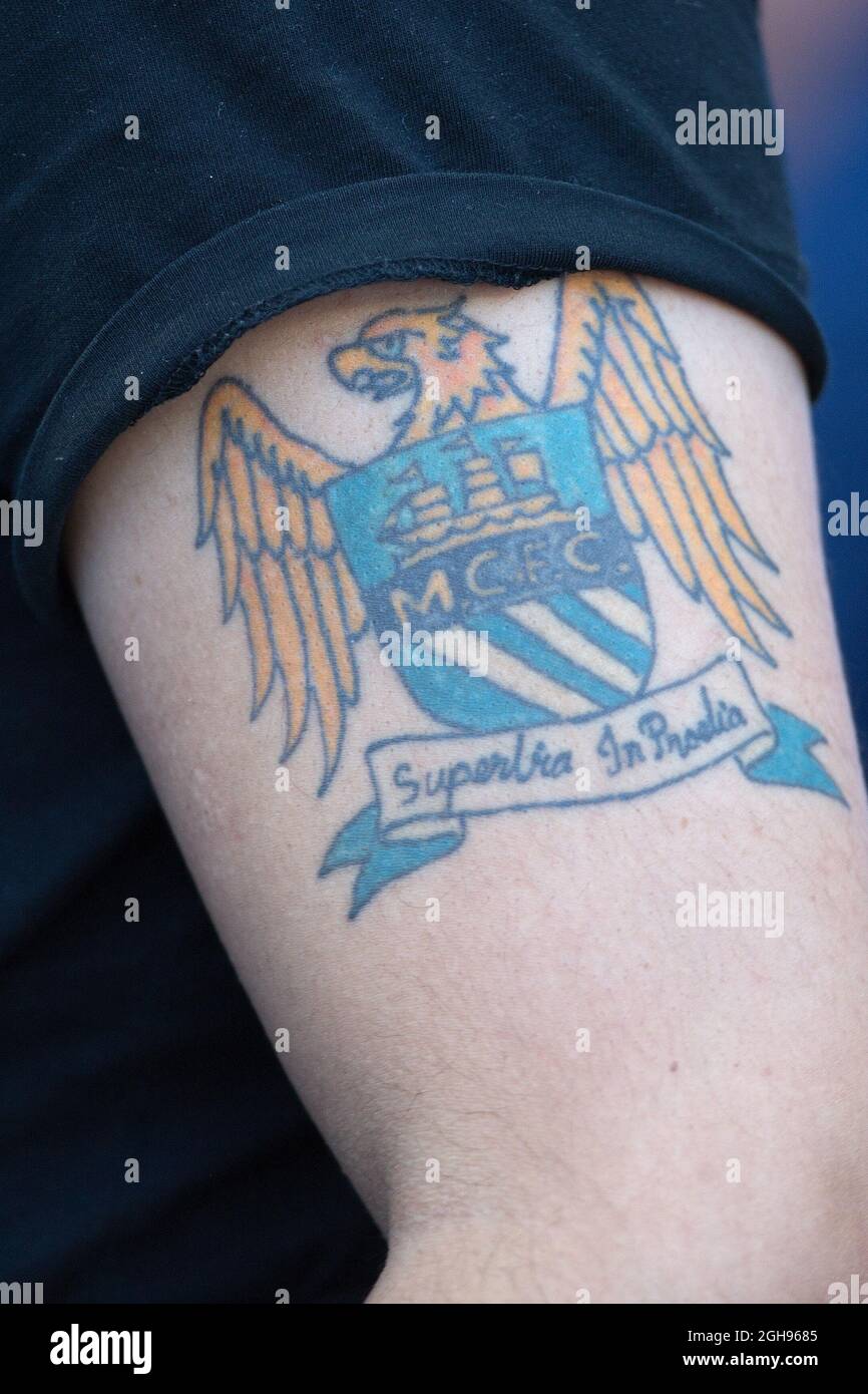 A Manchester City fan with a club crest tattoo during the Barclays Premier League match between Manchester City and Manchester United held at Etihad Stadium in Manchester, UK on September 22, 2013. A Manchester City fan with a club crest tattoo during the Barclays Premier League match between Manchester City and Manchester United held at Etihad Stadium in Manchester, UK on September 22, 2013.