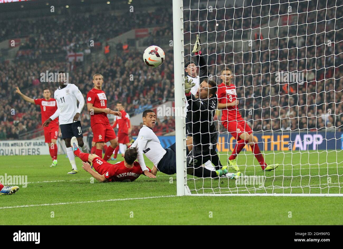 England's Chris Smalling can only watch as the ball just goes wide of Poland's Wojciech Szczesny's post during their FIFA World Cup 2014 qualifier soccer match between England and Poland at the Wembley in London, England, Oct. 15, 2013. Pic David Klein Stock Photo