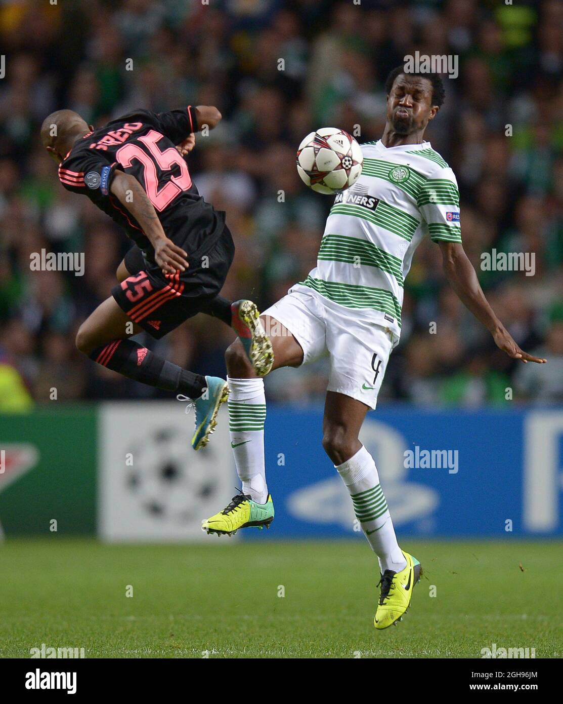 Thulani Serero of Ajax looses the ball to Efe Ambrose of Celtic during UEFA Champions League Group H match between Celtic and Ajax at Celtic Park Stadium on Oct. 22, 2013, Glasgow, Scotland, Stock Photo