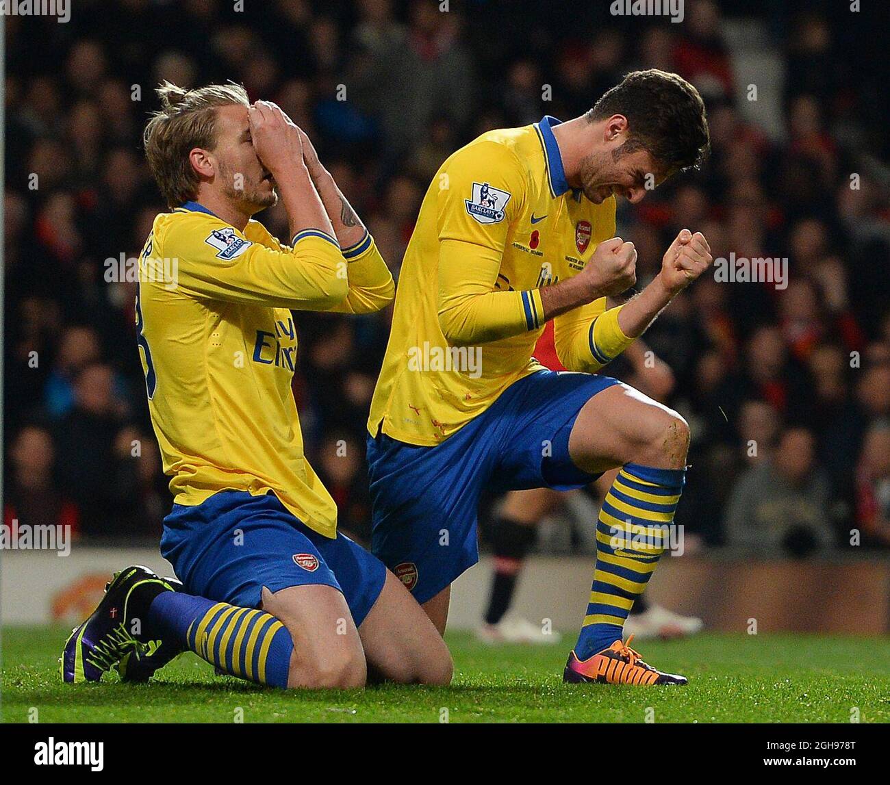Nicklas Bendtner and Olivier Giroud of Arsenal react to a last minute
