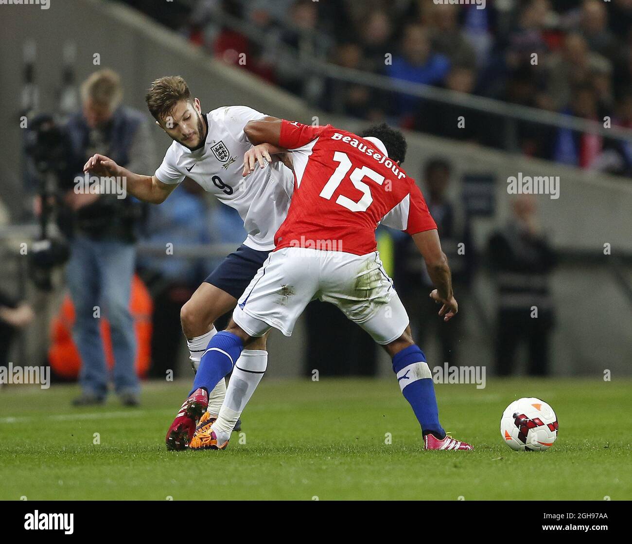 England's Adam lallana tussles with Chile's Jean Beausejour during the International Friendly match between England and Chile held at the Wembley Stadium in London, England on Nov. 15, 2013. Stock Photo