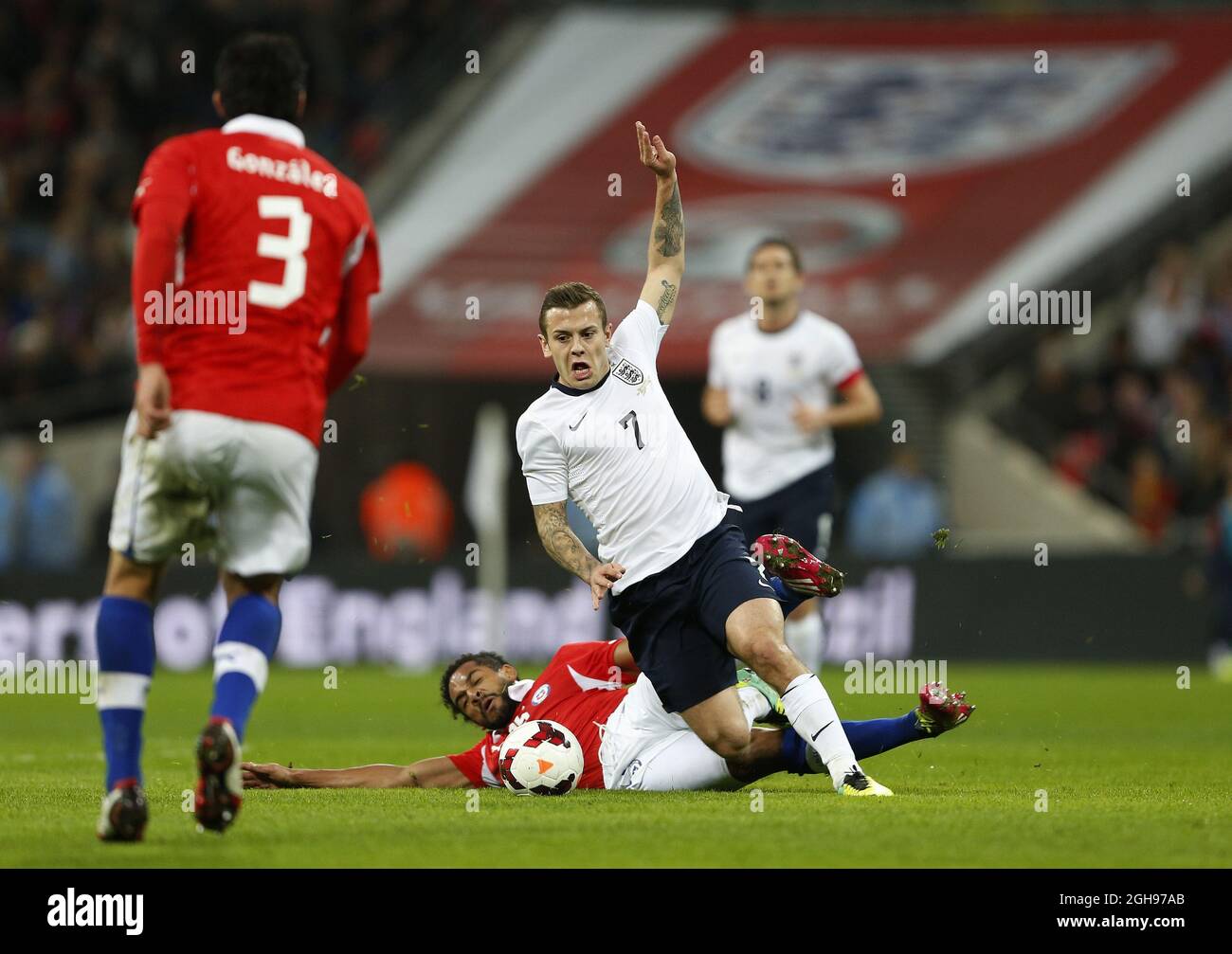 England's Jack Wilshere gets fouled by Chile's Jean Beausejour during the International Friendly match between England and Chile held at the Wembley Stadium in London, England on Nov. 15, 2013. Stock Photo