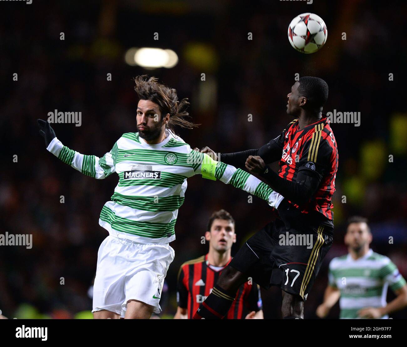Cristian Zapata of AC Milan clears the ball under pressure from Giorgos Samaras of Celtic during the UEFA Champions League Group H match between Celtic and AC Milan held at Celtic Park in Glasgow, Scotland on Nov. 26, 2013. Stock Photo