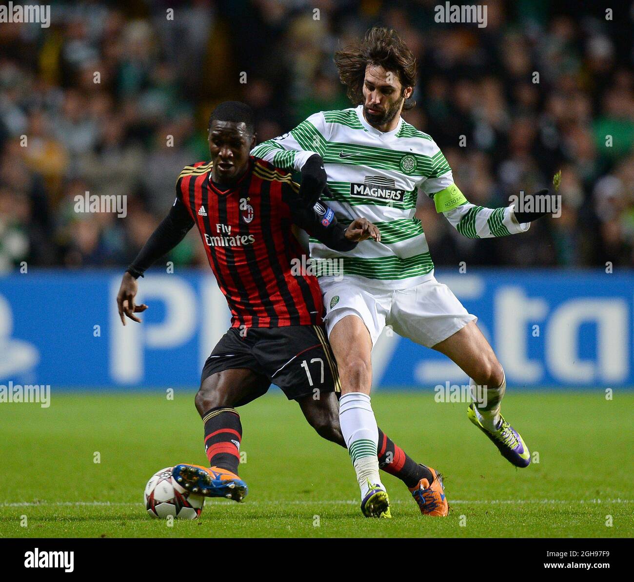 Cristian Zapata of AC Milan in action with Giorgos Samaras of Celtic during the UEFA Champions League Group H match between Celtic and AC Milan held at Celtic Park in Glasgow, Scotland on Nov. 26, 2013. Stock Photo