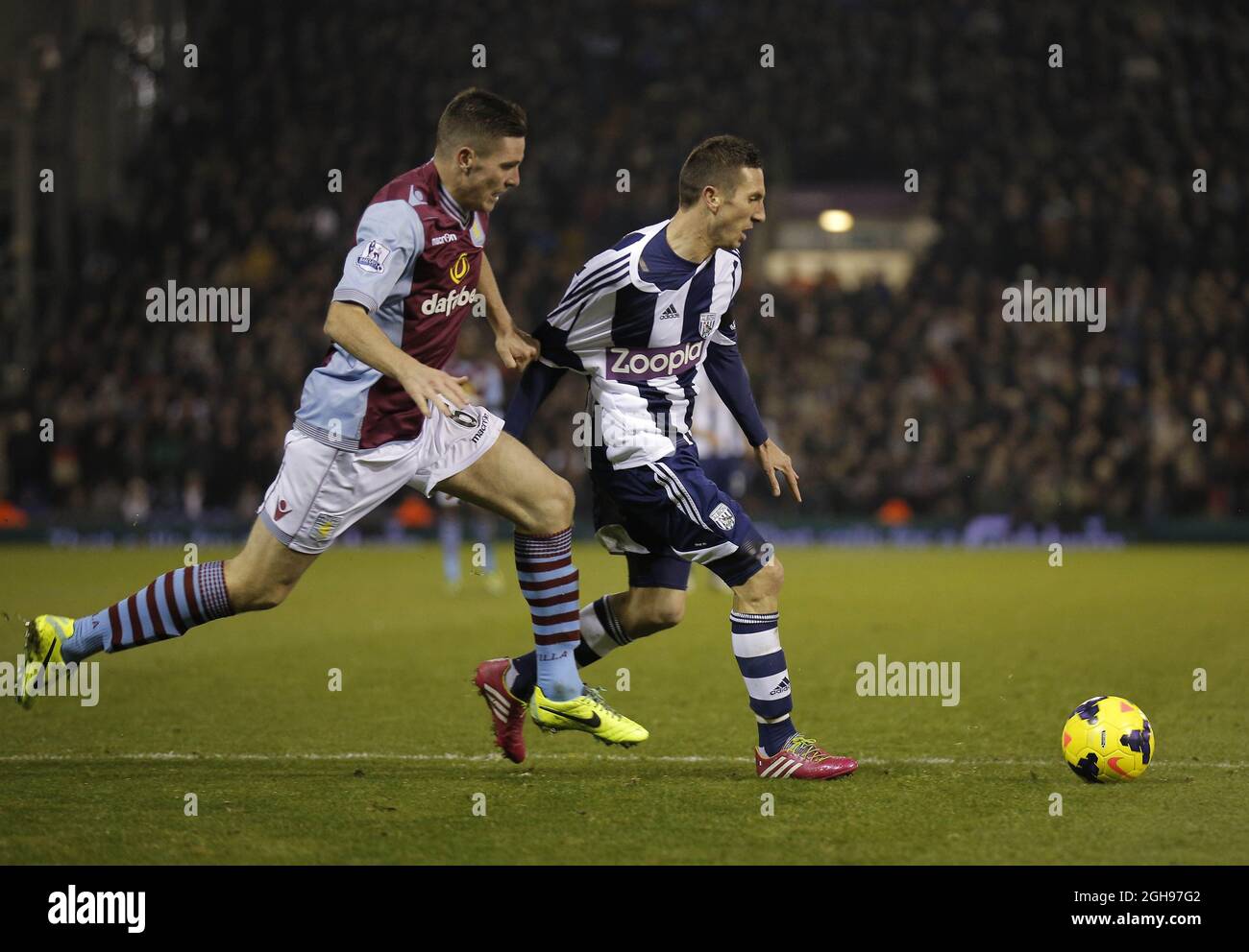 Morgan Amalfitano of West Brom goes past Ciaran Clark of Aston Villa during the Barclays Premier League match between West Bromwich Albion and Aston Villa in The Hawthorns, West Bromwich on November 25, 2013. Stock Photo