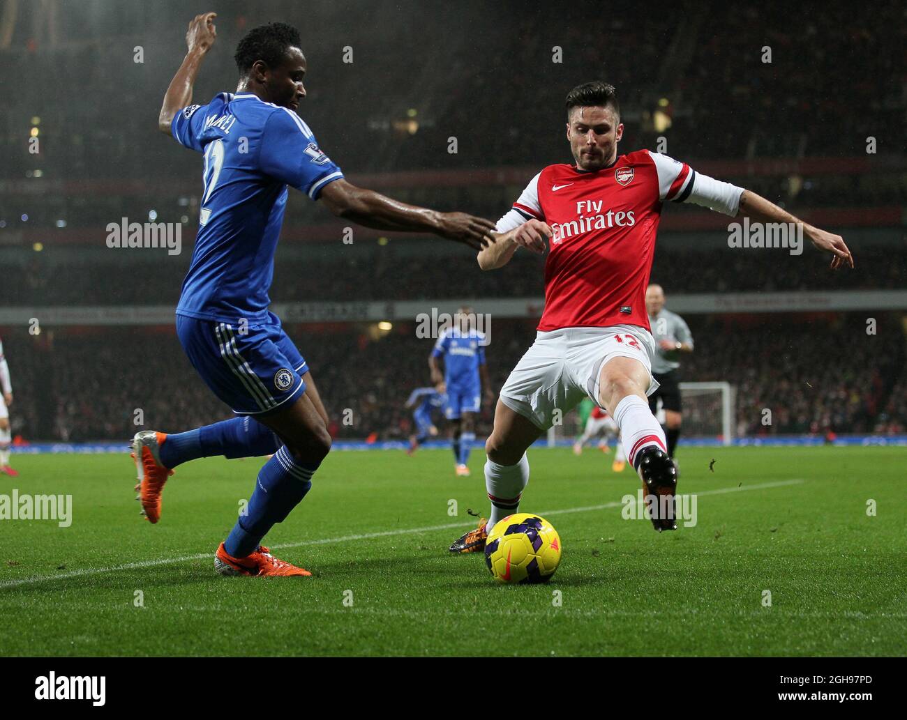 Arsenal's Olivier Giroud tussles with Chelsea's John Mikel Obi during the Barclays Premier League match between Arsenal and Chelsea at Emirates Stadium in London, Britain on Dec. 23, 2013. Pic David Klein Stock Photo