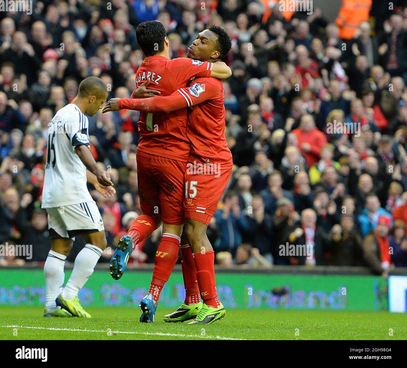 Daniel Sturridge of Liverpool celebrates his second goal with provider Luis Suarez of Liverpool during the Barclays Premier League match between Liverpool and Swansea City held at the Anfield Stadium in Liverpool, England on Feb. 23, 2014. Stock Photo