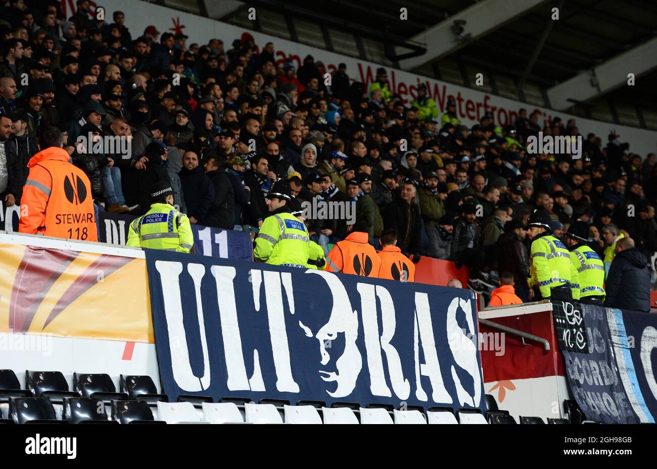 Napoli Ultras display their banner while being watched by police and stewards during the UEFA Europa League, round of 32 match between Swansea City and Napoli held at Liberty Stadium in Swansea, Wales on 20th February 2014. Stock Photo