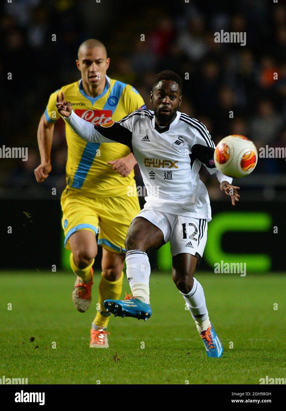 Nathan Dyer of Swansea City holds off Gokhan Inler of Napoli during the UEFA Europa League, round of 32 match between Swansea City and Napoli held at Liberty Stadium in Swansea, Wales on 20th February 2014. Stock Photo