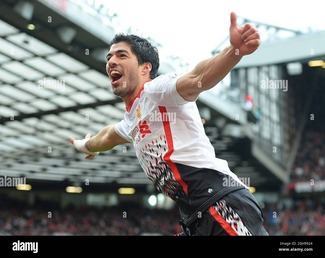 Luis Suarez of Liverpool celebrates scoring the third goal during the Barclays Premier League match between Manchester Utd and Liverpool at Old Trafford Stadium in Manchester, England on March 16, 2014. Pic Simon Bellis Stock Photo