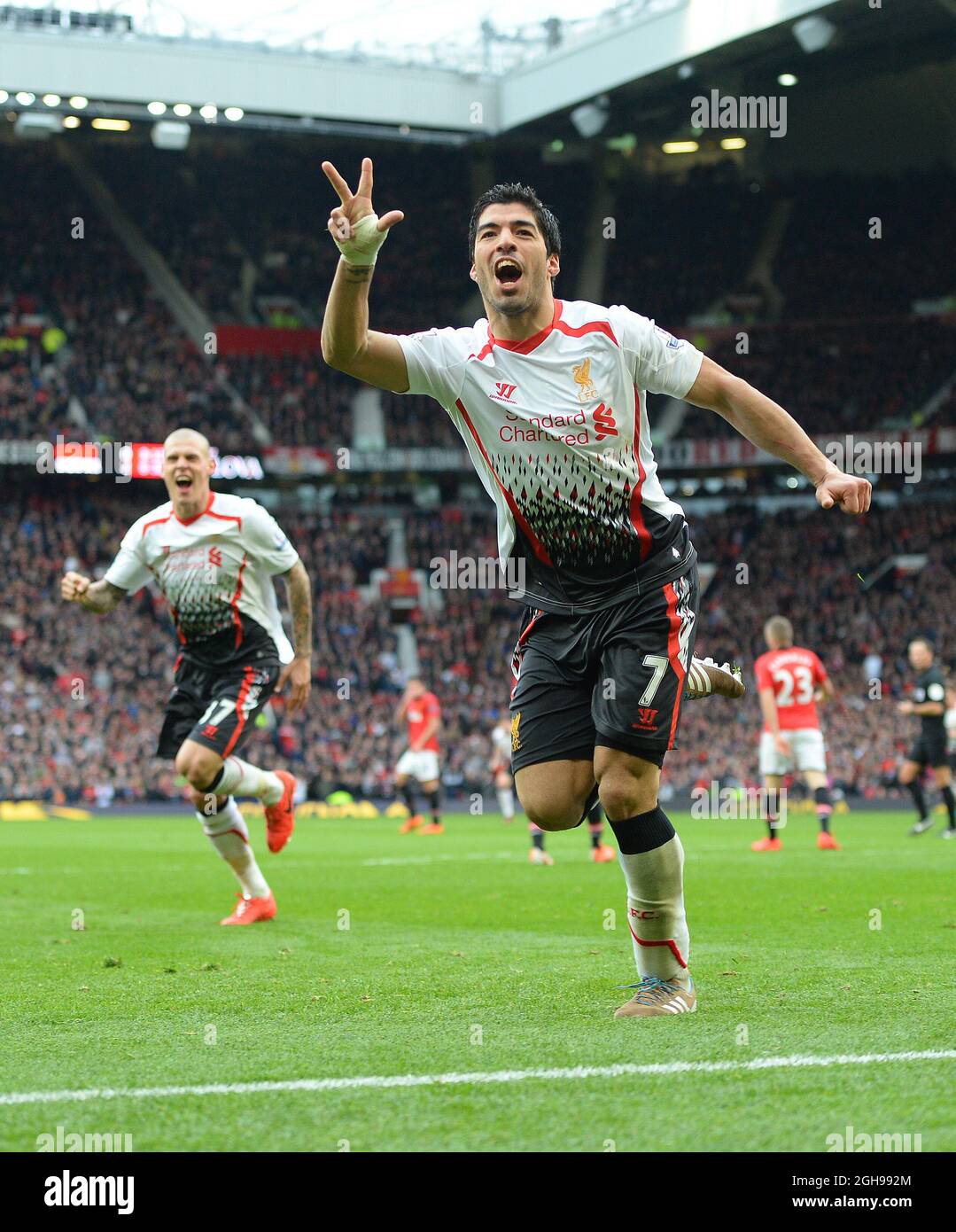Luis Suarez of Liverpool celebrates scoring the third goal during the Barclays Premier League match between Manchester Utd and Liverpool at Old Trafford Stadium in Manchester, England on March 16, 2014. Pic Simon Bellis Stock Photo
