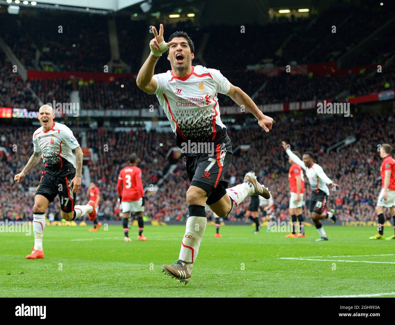 Luis Suarez of Liverpool celebrates scoring the third goal during the Barclays Premier League match between Manchester United and Liverpool held at the Old Trafford Stadium in Manchester, England on March 16, 2014. Pic Simon Bellis Stock Photo