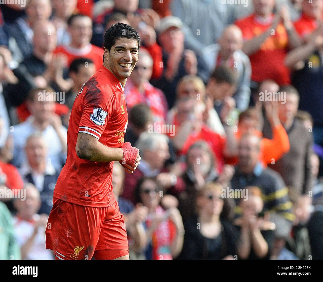 Luis Suarez of Liverpool celebrates scoring the second goal during the Barclays Premier League match between Liverpool and Tottenham at the Anfield Stadium in Liverpool, England on March 30, 2014. Stock Photo