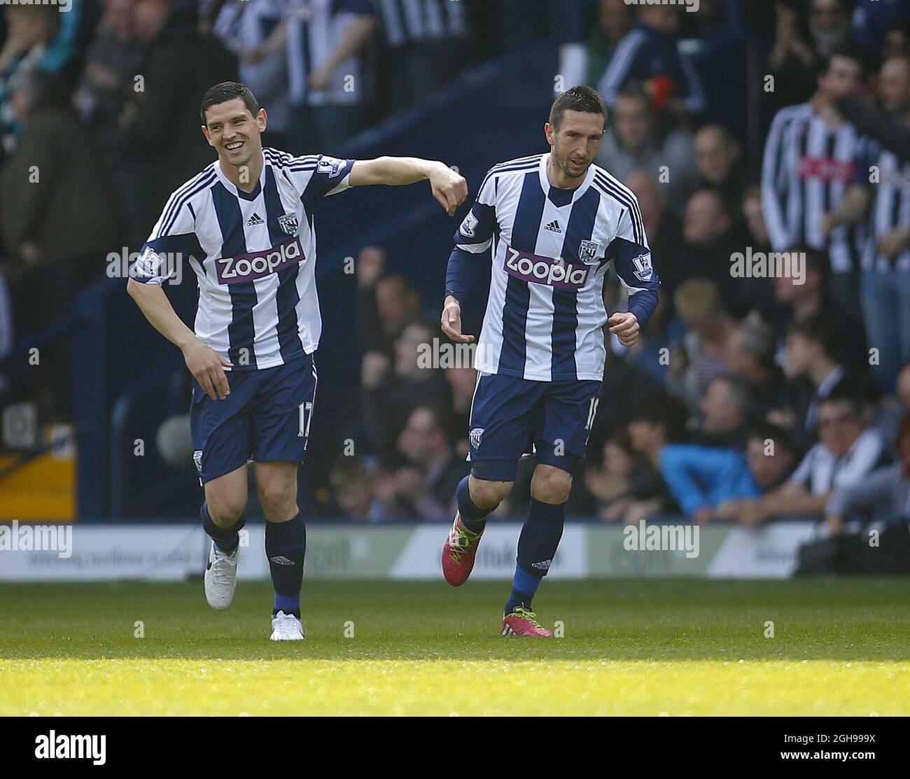 Scorers both, Graham Dorrans congratulates Morgan Amalfitano following the first goal of the game for West Bromwich Albion during the Barclays Premier League match between West Bromwich Albion and Cardiff City held at the Hawthorns in West Bromwich on March 29, 2014. Stock Photo