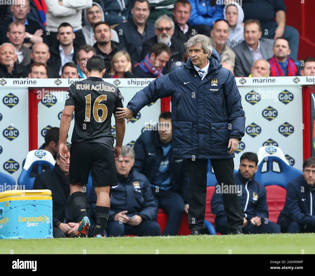 Manchester City's Manuel Pellegrini consoles Sergio Aguero as he goes off injured during the Barclays Premier League match between Crystal Palace and Manchester City at Selhurst Park, London, UK on April 27, 2014. Stock Photo