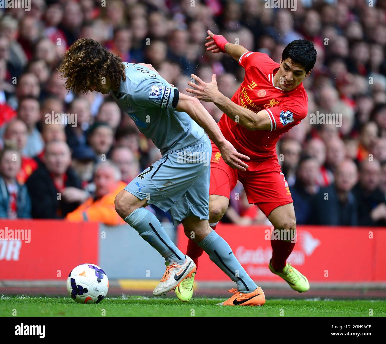 Fabricio Coloccini of Newcastle United tussles with Luis Suarez of Liverpool during Barclays Premier League match between Liverpool and Newcastle United at Anfield in Liverpool, United Kingdom on May 11, 2014. Pic Simon Bellis. Stock Photo