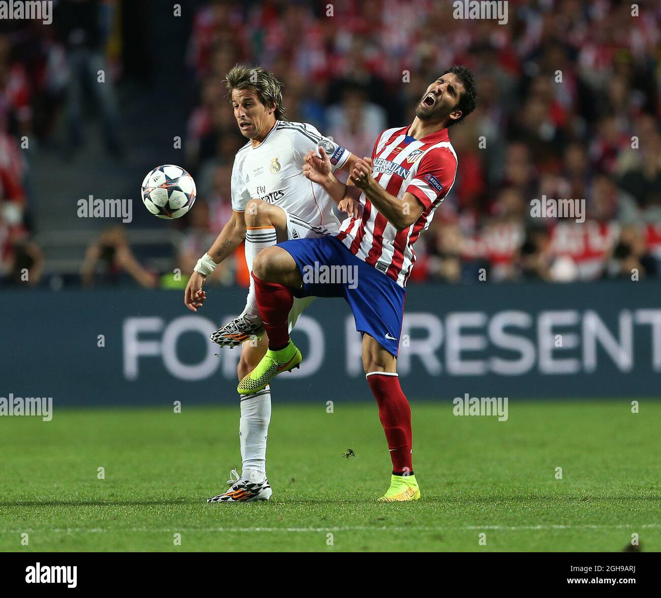 Real Madrid Fabio Coentrao tussles with Atletico Madrid's Raul Garcia during the UEFA Champions League soccer final match between Real Madrid and Atletico Madrid at Estadio da Luz Stadium in Lisbon, Portugal on May 24, 2014. Pictured by David Klein/Sportimage. Stock Photo