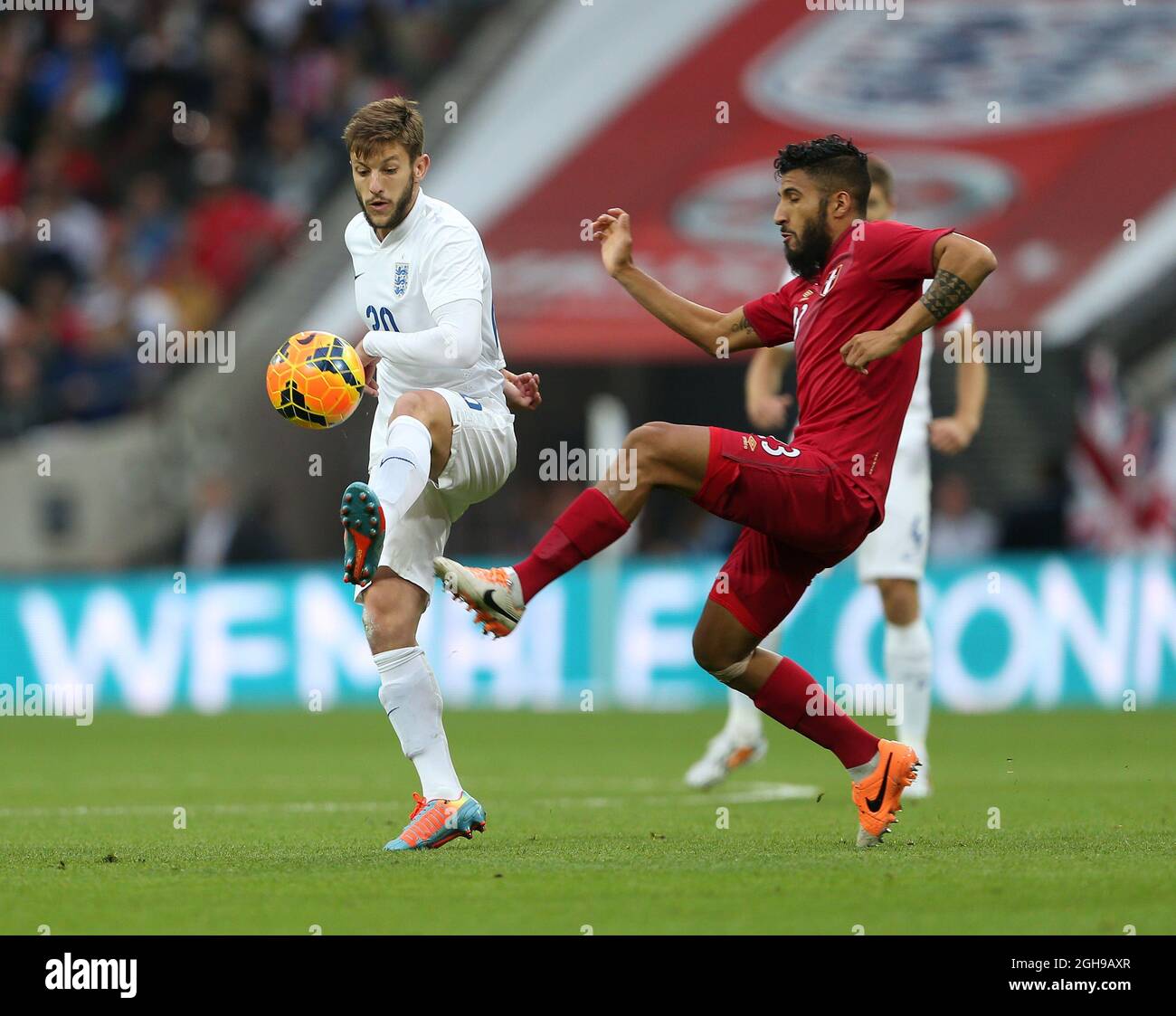 England's Adam Lallana tussles with Peru's Josepmir Ballon during the international friendly match between England and Peru at Wembley Stadium on May 30, 2014 in London, England. Pic Charlie Forgham-Bailey/Sportimage. Stock Photo