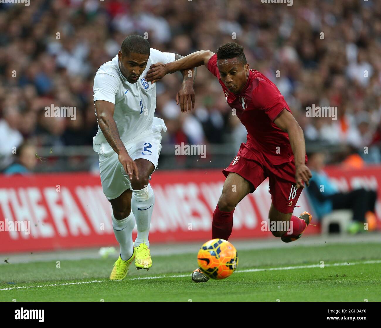 England's Glen Johnson tussles with Peru's Andre Carrillo during the international friendly match between England and Peru at Wembley Stadium on May 30, 2014 in London, England. Pic Charlie Forgham-Bailey/Sportimage. Stock Photo