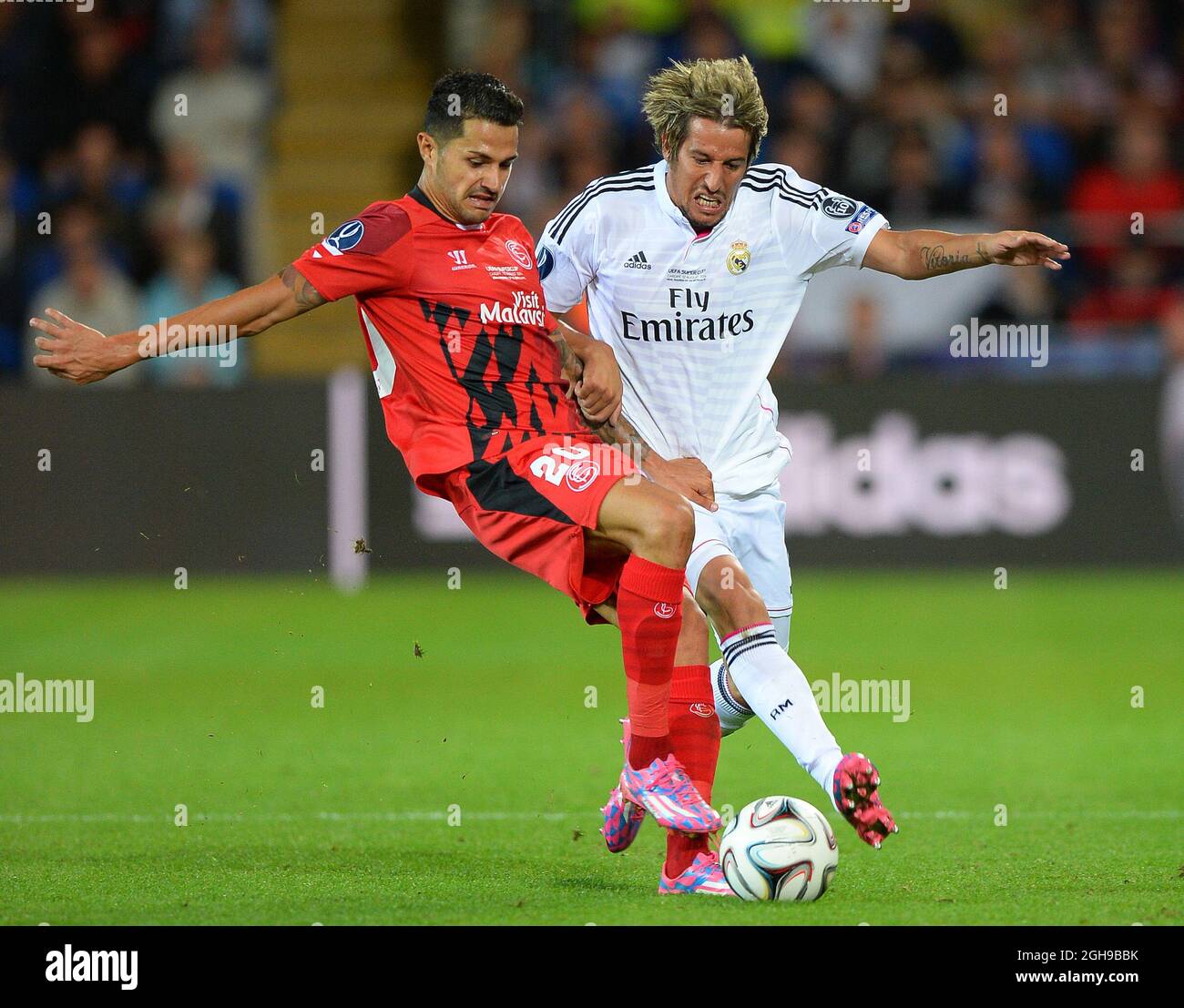 Vitolo of Sevilla tackled by Fabio Coentrao of Real Madrid during the UEFA Super Cup match between Real Madrid and Sevilla at Cardiff City Stadium in Cardiff, Britain on Aug. 12, 2014. Real Madrid won the title by beating Sevilla with 2-0. Pic Simon Bellis/Sportimage. Stock Photo