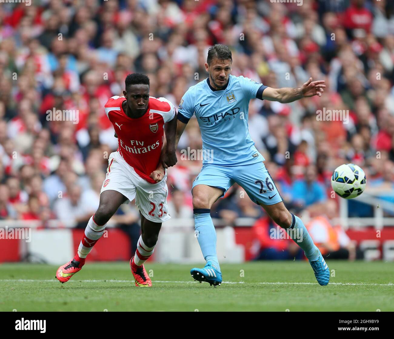 Arsenal's Danny Welbeck tussles with Manchester City's Martin Demichelis during the Barclays Premier League the match between Arsenal and Manchester City at Emirates Stadium on September 13, 2014. Stock Photo