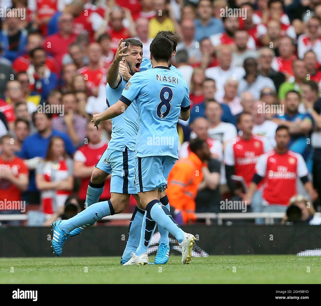 Manchester City's Martin Demichelis celebrates scoring his sides second goal during the Barclays Premier League the match between Arsenal and Manchester City at Emirates Stadium on September 13, 2014. Stock Photo