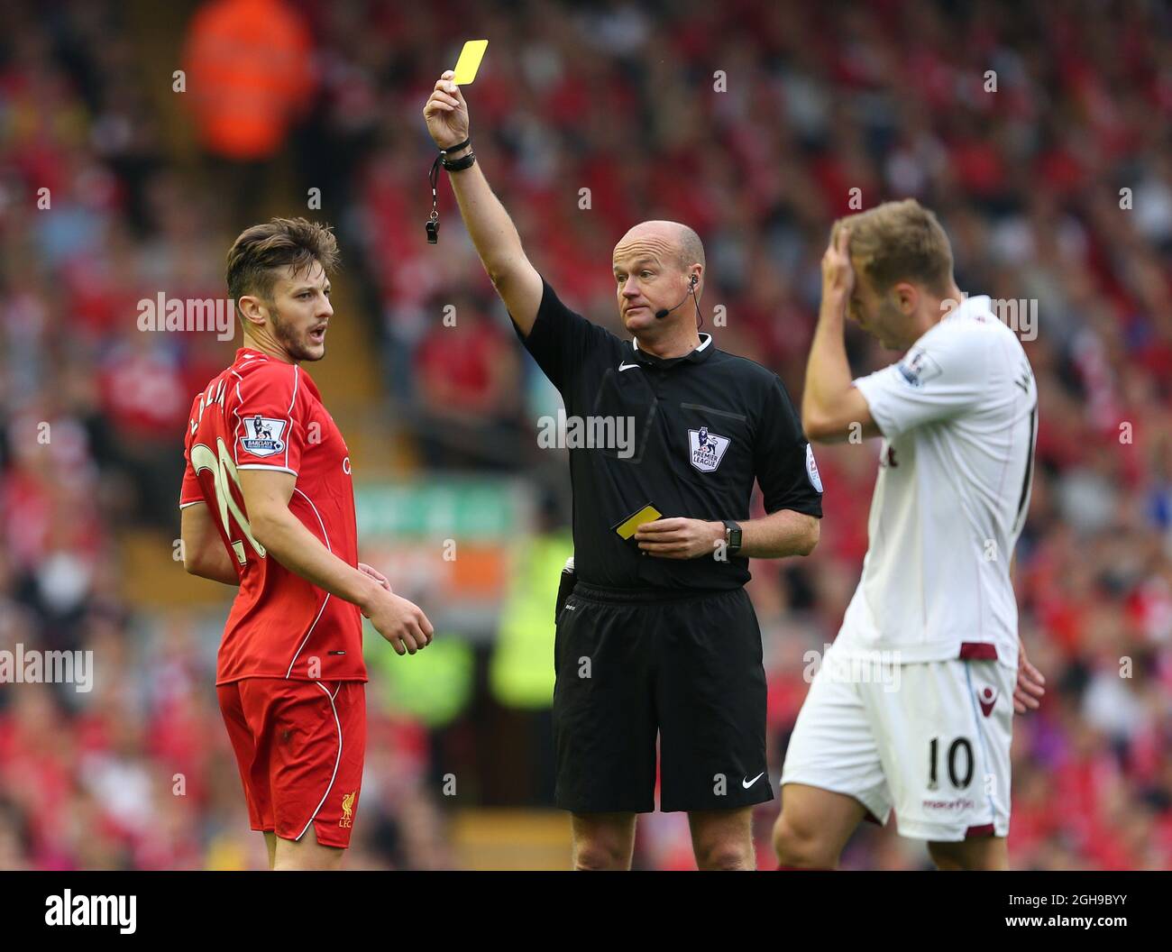 Adam Lallana of Liverpool receives a yellow card during the English Premier League soccer match at Anfield in Liverpool, northern England September 13, 2014. Stock Photo