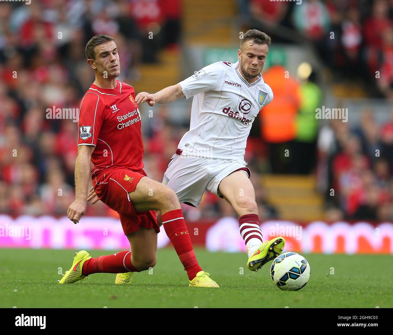 Jordan Henderson of Liverpool tackled by Tom Cleverley of Aston Villa during their English Premier League soccer match at Anfield in Liverpool, northern England September 13, 2014. Stock Photo