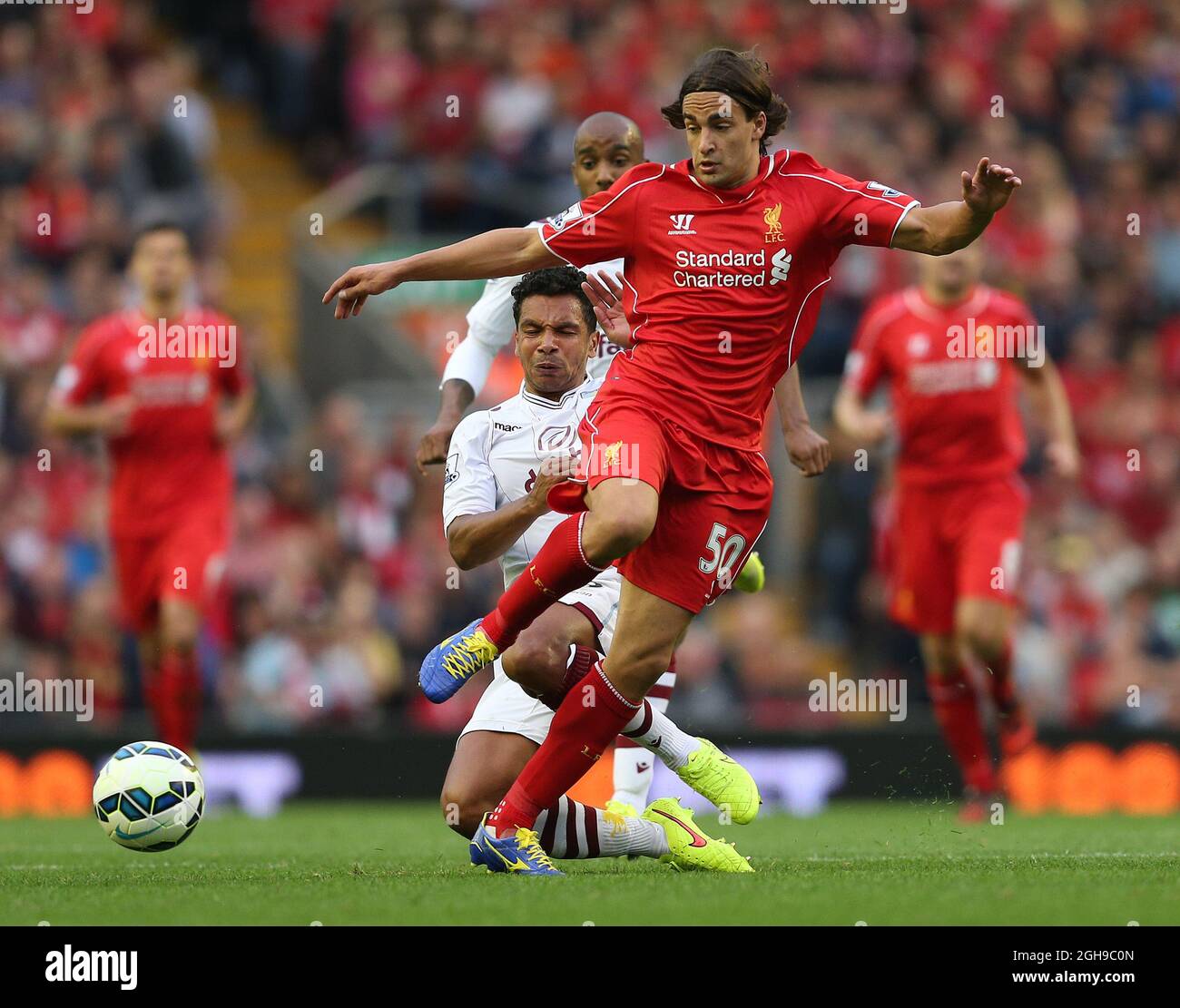 Lazar Markovic of Liverpool tackled by Kieran Richardson of Aston Villa during their English Premier League soccer match at Anfield in Liverpool, northern England September 13, 2014. Stock Photo