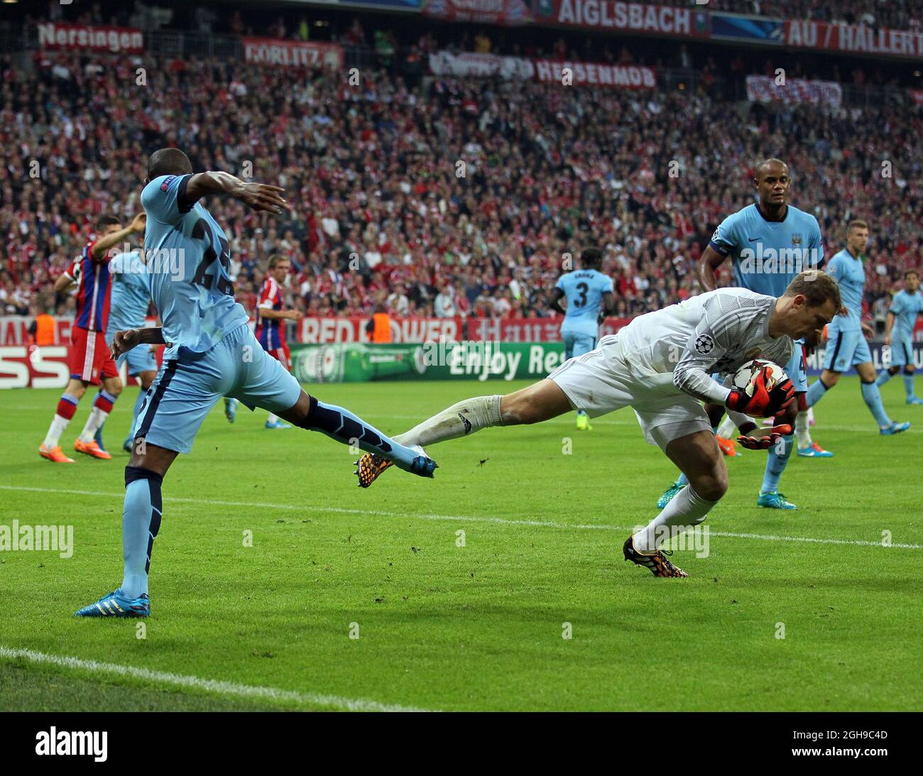 Bayern Munich's Manuel Neuer gets caught late by Manchester City's Fernandinho during the Champions League Group E match between Bayern Munich and Manchester City held at Allianz Arena in Germany on Sept. 17, 2014 . Stock Photo