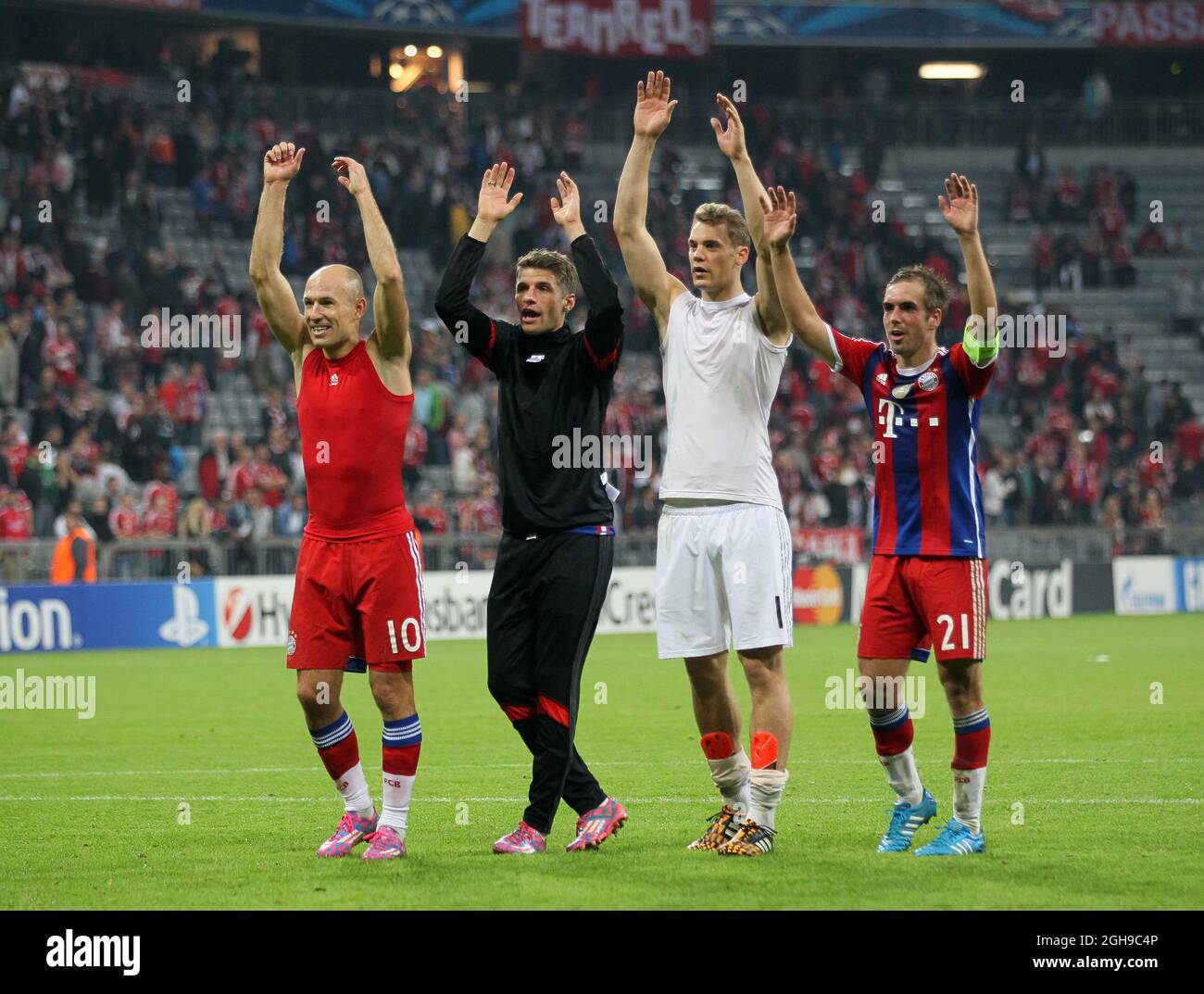 Munich's Arjen Robben, Thomas Muller, Manuel Neuer and Philipp Lahm celebrate at the final whistle during the Champions League Group E match between Bayern Munich and Manchester City held at Allianz Arena in Germany on Sept. 17, 2014 . Stock Photo