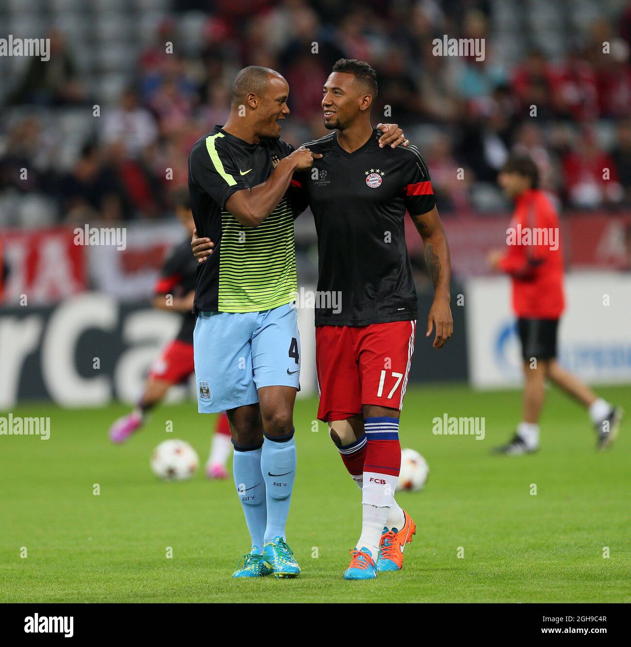 Manchester City's Vincent Kompany greets former teammate Bayern Munich's Jerome Boateng during the Champions League Group E match between Bayern Munich and Manchester City held at Allianz Arena in Germany on Sept. 17, 2014 . Stock Photo