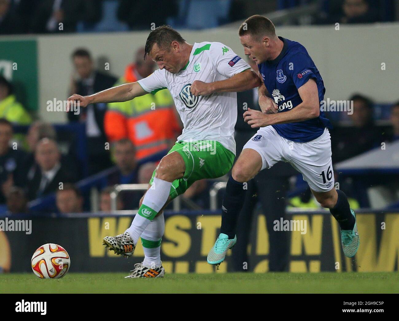 Ivica Olic of Wolfsburg tussles with James McCarthy of Everton during the UEFA Europa League Group H match between Everton and VfL Wolfsburg at Goodison Park, Liverpool on September 18, 2014. Stock Photo