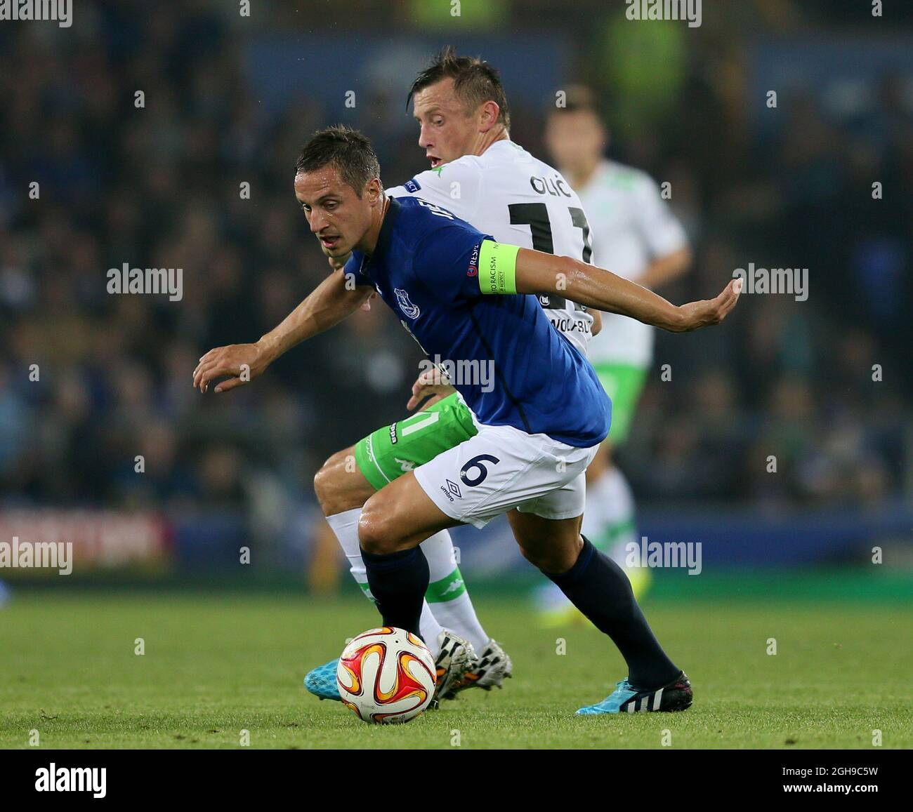 Ivica Olic of Wolfsburg puts pressure on Phil Jagielka of Everton during the UEFA Europa League Group H match between Everton and VfL Wolfsburg at Goodison Park, Liverpool on September 18, 2014. Stock Photo