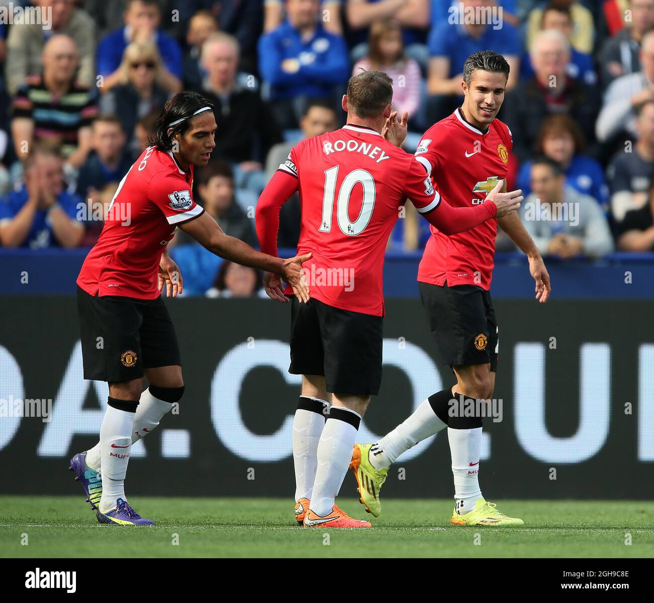 Radamel Falcao of Manchester United and Wayne Rooney of Manchester United celebrate with scorer Robin van Persie of Manchester United (r) - Barclays Premier League during the Barclays Premier League match at King Power Stadium 21 September 2014. Stock Photo