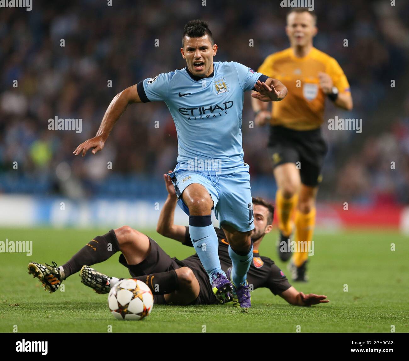 Miralem Pjanic of Roma tackles Sergio Aguero of Manchester City during UEFA Champions League group E match between Manchester City and Roma held at Etihad Stadium in Manchester, England on 30th September 2014. Stock Photo