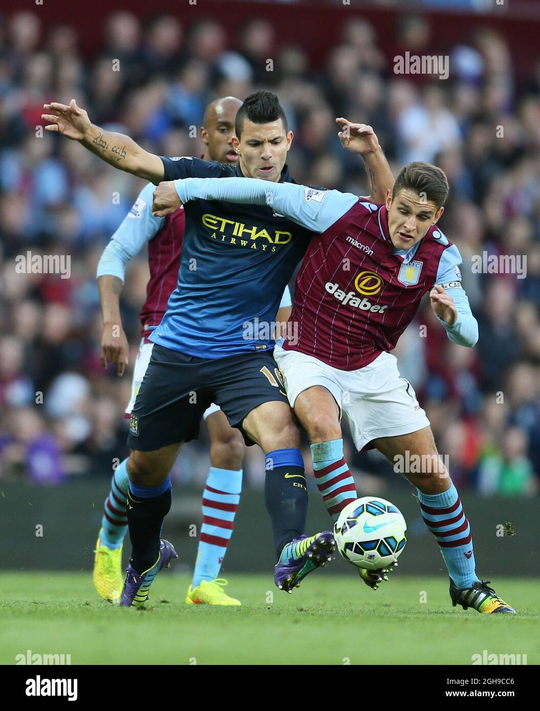 Sergio Aguero of Manchester City tussles with Ashley Westwood of Aston Villa during the Barclays Premier League match between Aston Villa and Manchester City at the Villa Park in England on October 04, 2014. Stock Photo