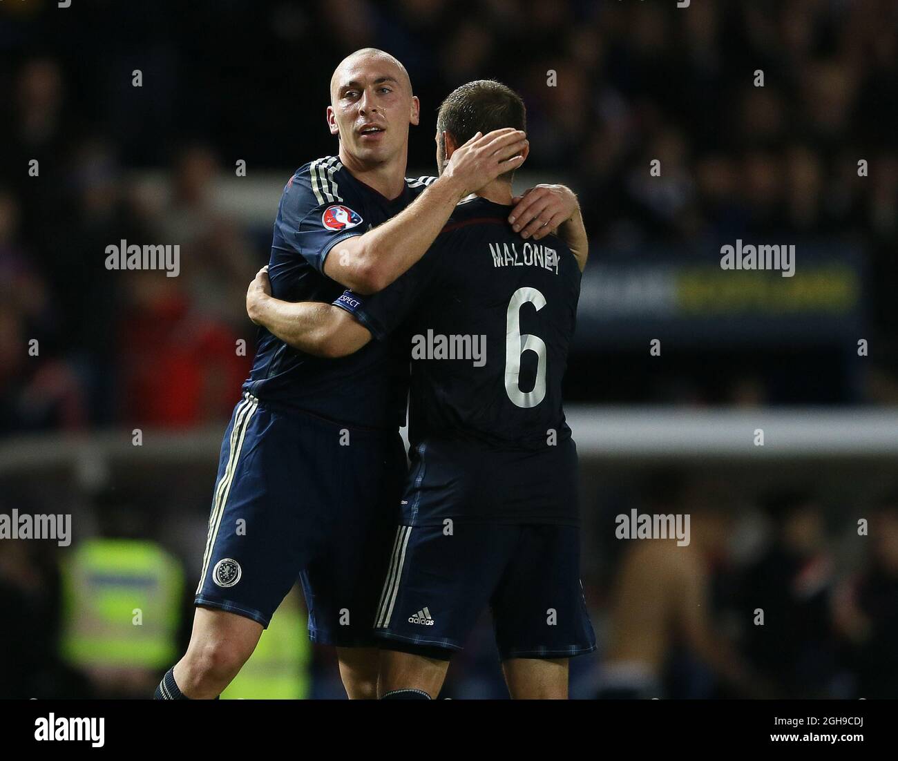 Man of the match Scott Brown of Scotland hugs winning goalscorer Shaun Maloney of Scotland at the end of the match during the Euro 2016 Qualifying Group D match between Scotland and Georgia at the Ibrox Stadium in England on October 11, 2014. Stock Photo