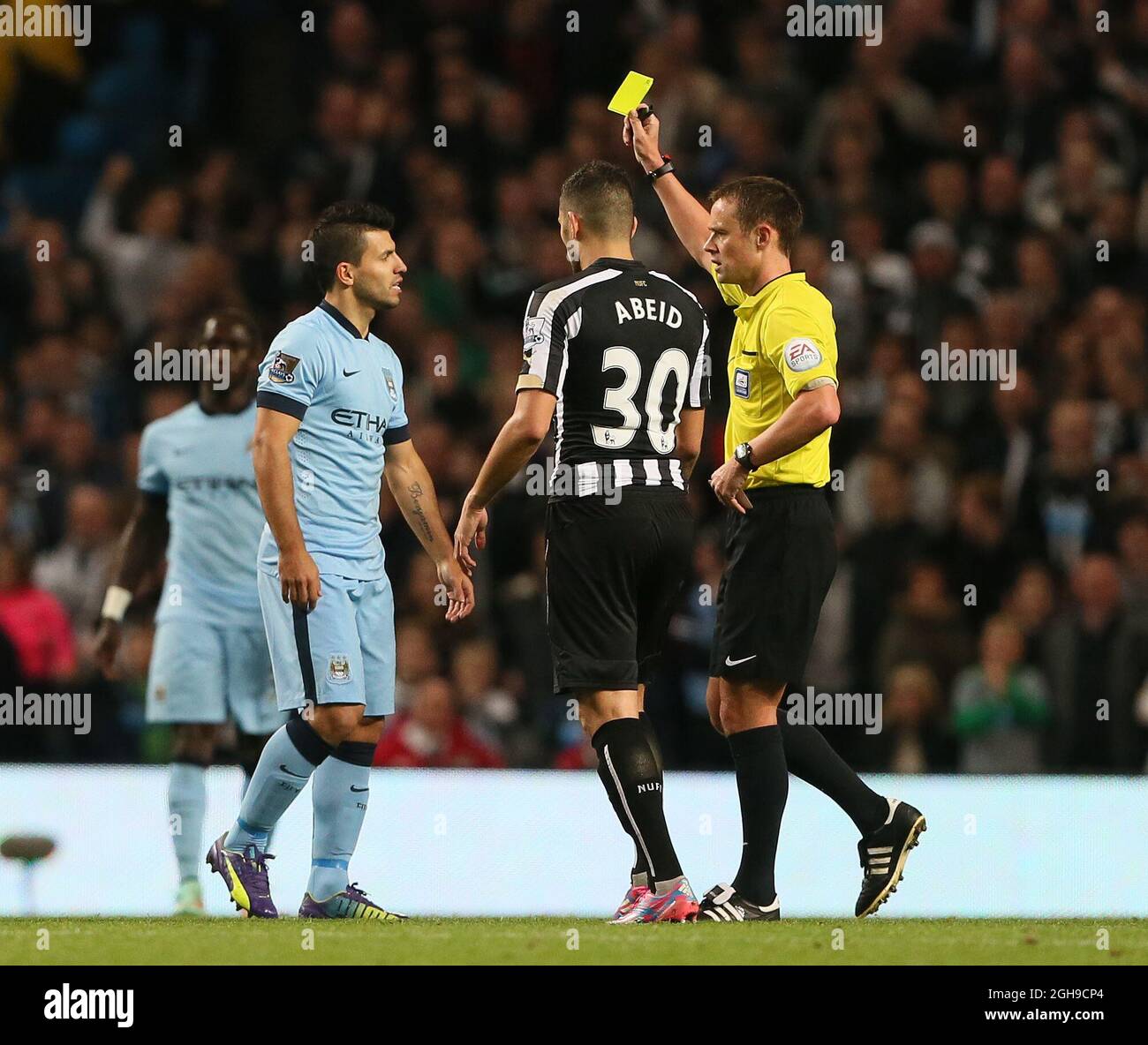 Manchester City's Sergio Aguero gets booked by referee Stuart Attwell during the Capital One Cup Fourth Round match between Manchester City and Newcastle United at the Etihad Stadium, London on 29, October 2014. Stock Photo