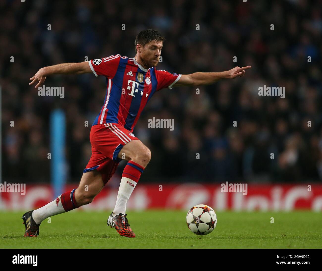 Xabi Alonso of Bayern Munich in action during the Champions League Group E match between Manchester City and Bayern Munich held at Etihad Stadium in England on Nov. 25, 2014. Stock Photo