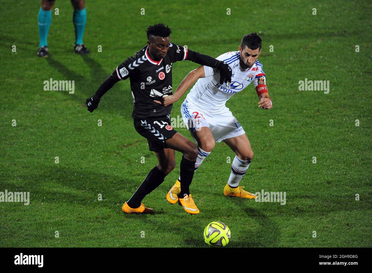 Benjamin Moukandjo and Maxime Gonalons tackles during Ligue 1 match between Stade de Reims and Lyon at the Stade de Gerland in France on December 04, 2014. Stock Photo